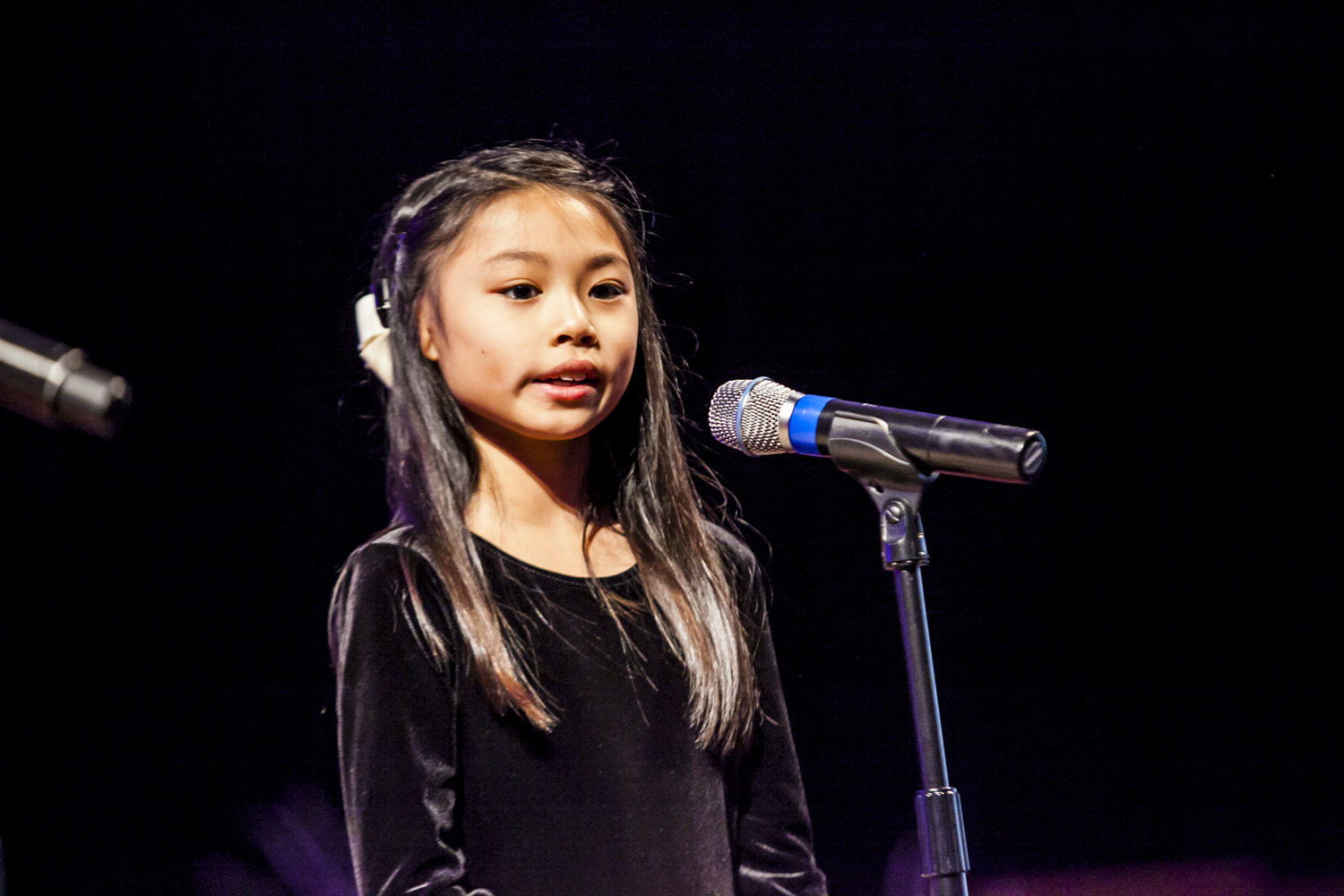 If you look closely, you can see Mia’s BAHA (Bone Anchored Hearing Aid) attached to the right side of her head. If you listen closely, you can hear the most beautiful second grade voice in the world…
